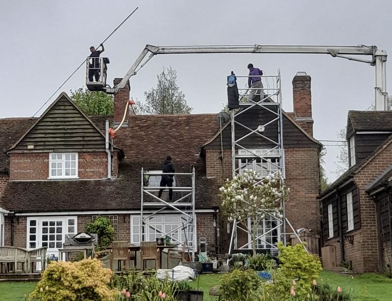 The Moss Cleaners using cherry picker and scaffolding to clean roof safely and professionally in Lydney, Gloucestershire